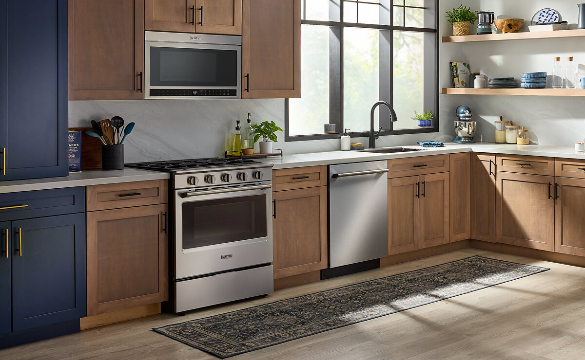 The interior of a kitchen with wood cabinetry and a gas stove