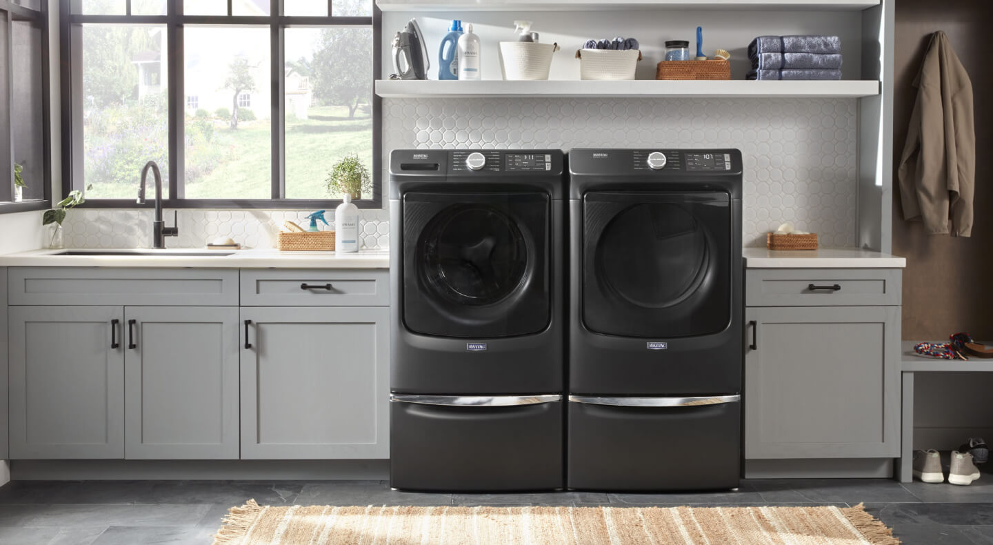 Maytag® front load washer and dryer in a modern laundry room