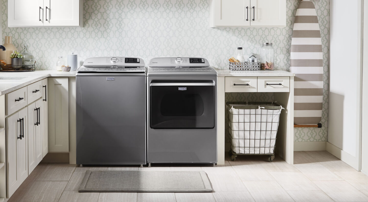 Maytag® top load washer and dryer in a modern laundry room