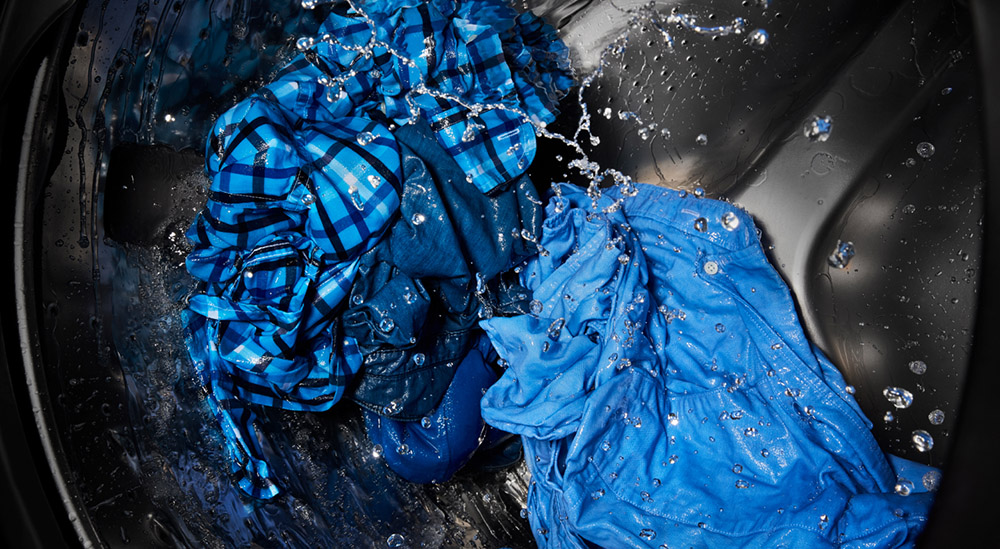 A closeup of clothing washing in a washer tub