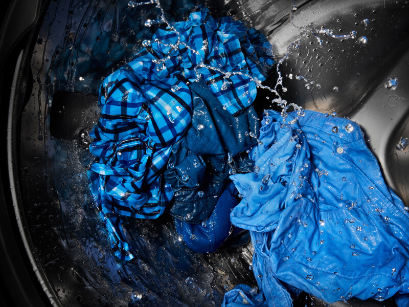 A closeup of clothing washing in a washer tub