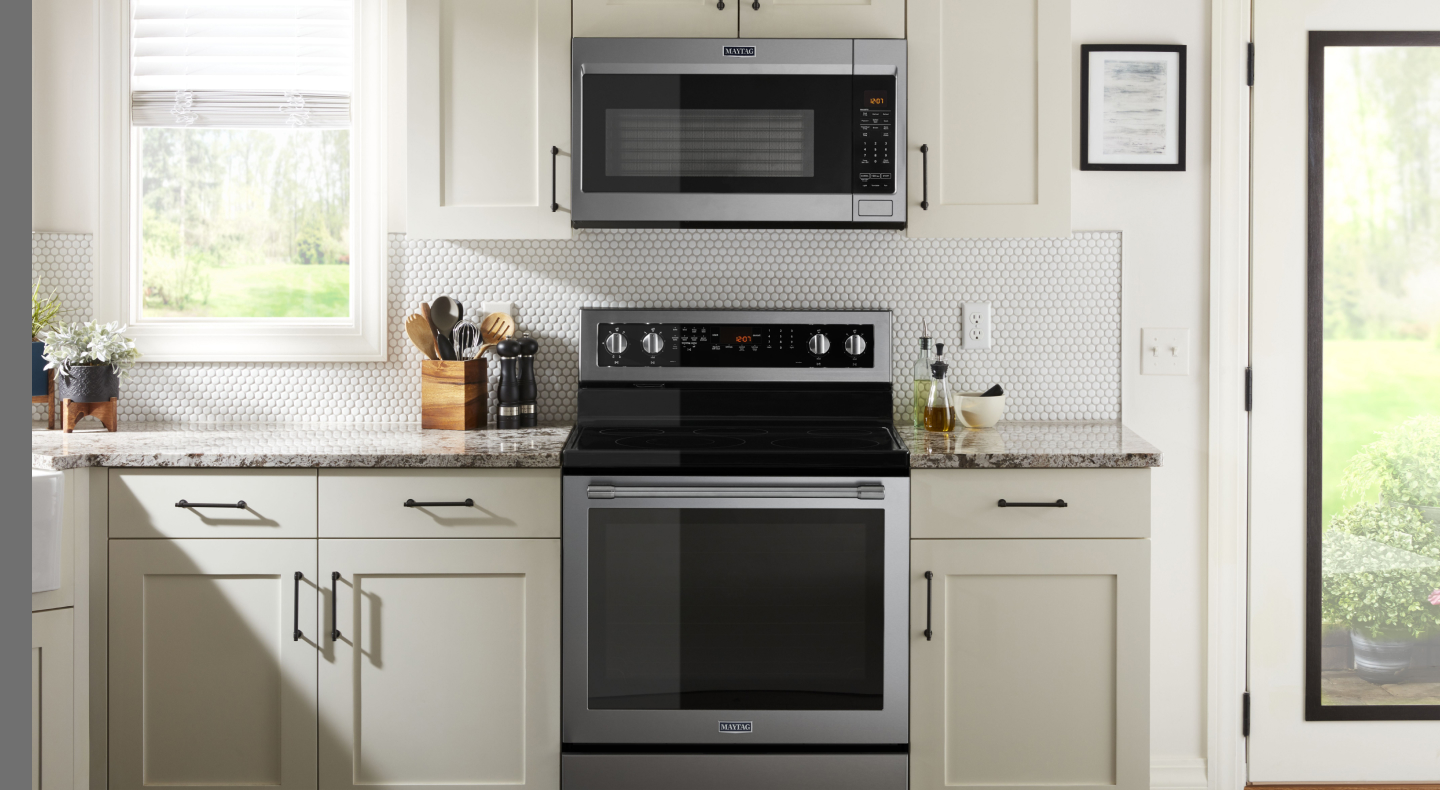 A Maytag® oven and over-the-range microwave in a modern kitchen.