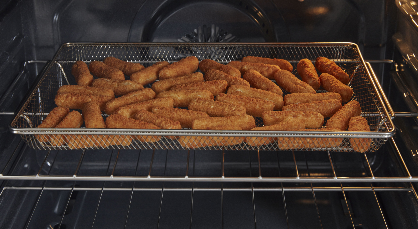 Mozzarella sticks in air fryer basket