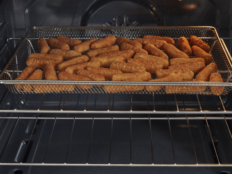 Mozzarella sticks in air fryer basket