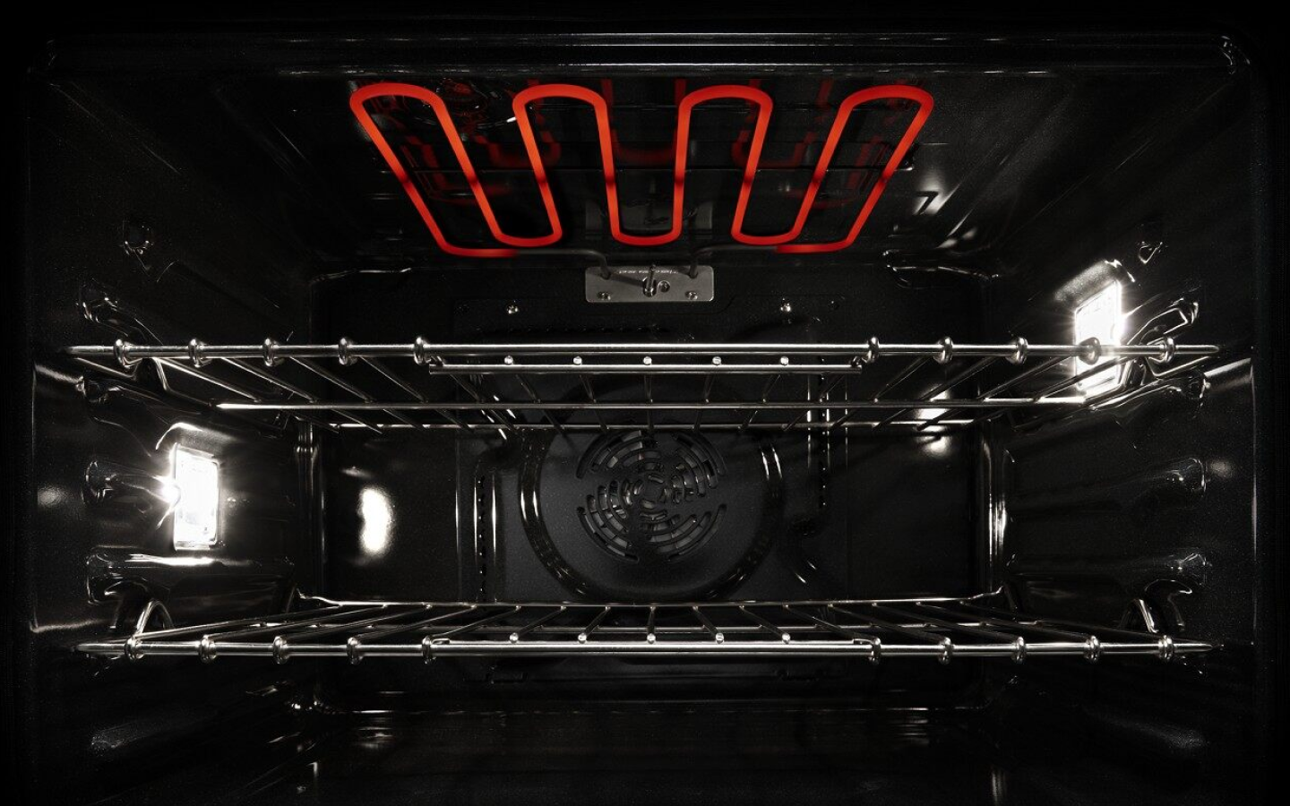 View of the inside of an active oven with red hot coils