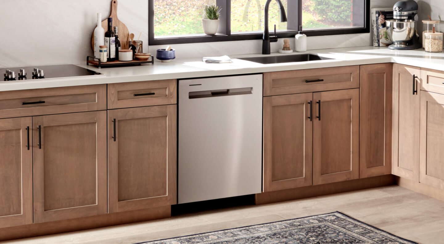 A Maytag® dishwasher in a kitchen with brown cabinets