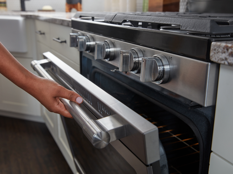 Person opening oven door