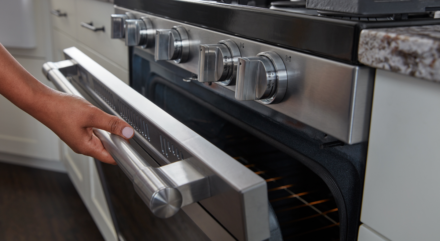 Person opening oven door