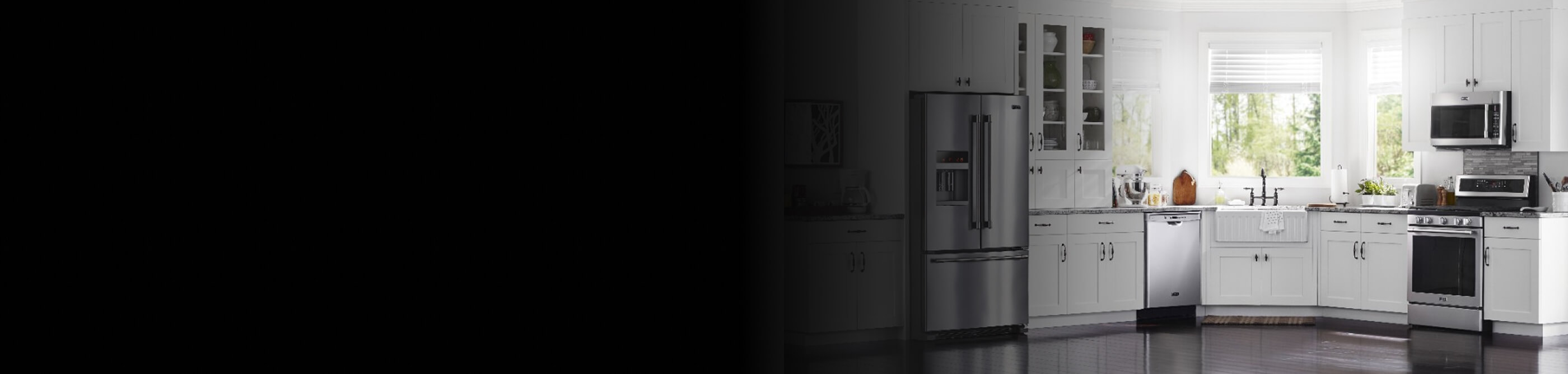 A beautiful, white kitchen with stainless steel appliances