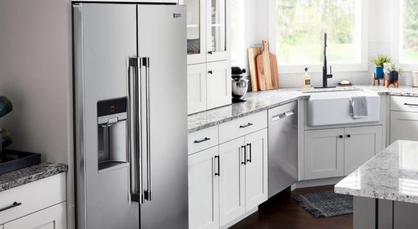 A French door counter-depth refrigerator in a cabinet cutout