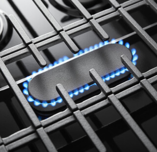 Blue flames simmering on a gas cooktop