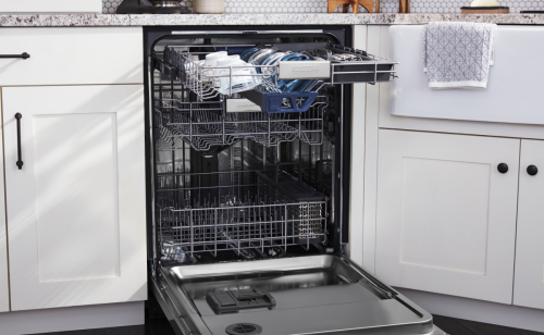 Open dishwasher set in white cabinetry