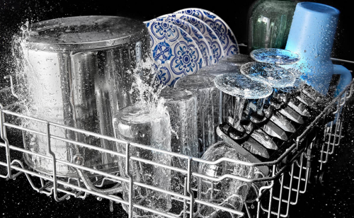 Glasses and plates being washed in a Maytag® dishwasher