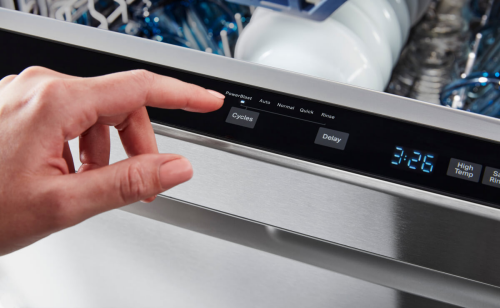 Person selecting cycle on a dishwasher