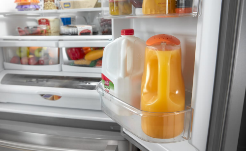 Orange juice and milk inside a refrigerator door
