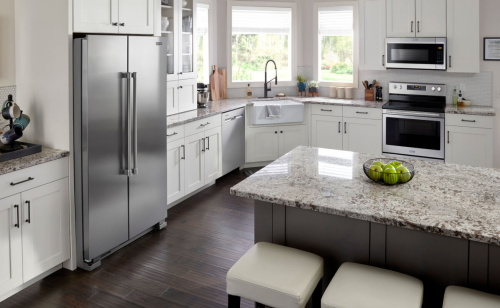 Kitchen with white cabinetry and stainless steel appliances