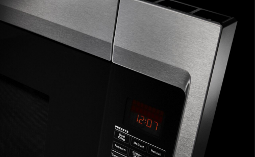 A close up image of a microwave door handle