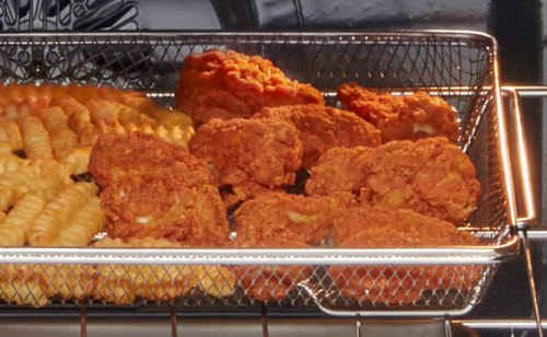 Fried chicken and fries in an air fry basket
