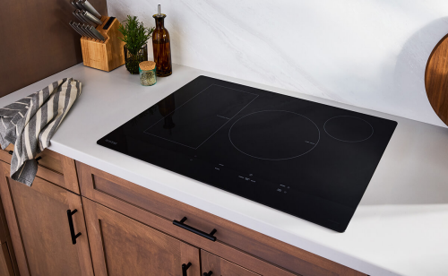 Maytag® induction cooktop installed in a white countertop