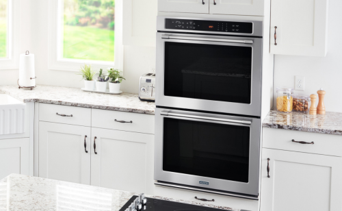 Stainless steel Maytag® electric range in brown cabinetry