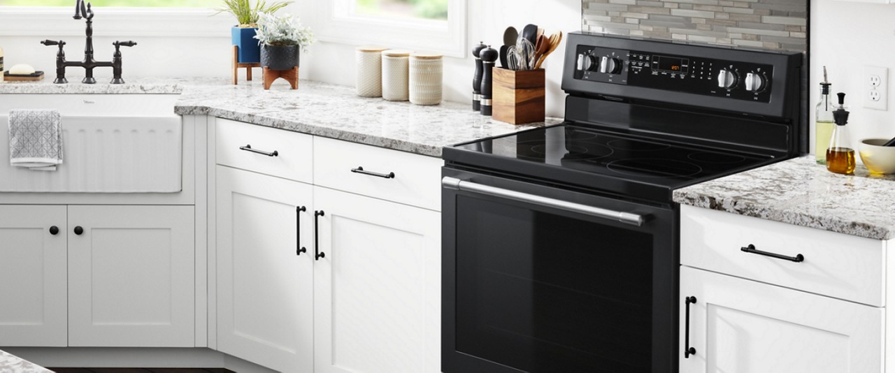 Black freestanding range in a white kitchen