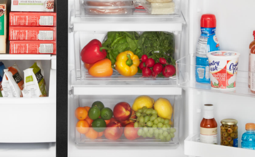 Close-up of produce and frozen food in side-by-side refrigerator