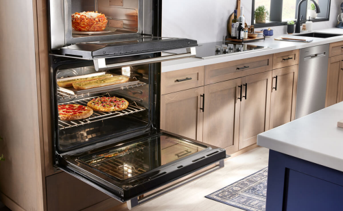 Wall oven open to show cooked food inside