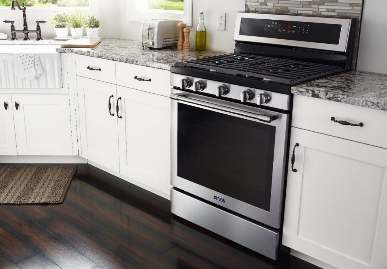 Freestanding gas range in a white kitchen
