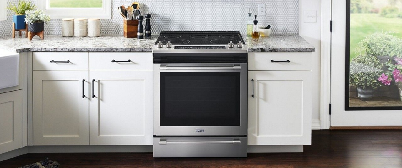 Slide-in electric range in a white kitchen