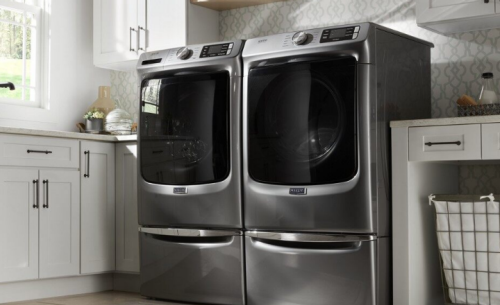 Front load laundry set in a white laundry room.