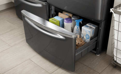 Close-up of open laundry pedestal drawer with laundry supplies inside