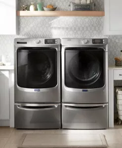A Maytag® washer and dryer with a light behind it