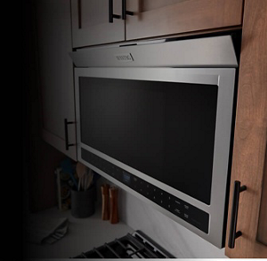 Maytag® over-the-range stainless steel microwave in brown cabinetry