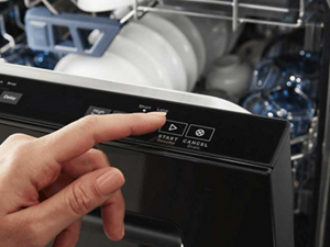 Person selecting dishwasher cycle on a top control dishwasher panel