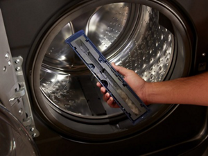 Person holding washer lint trap