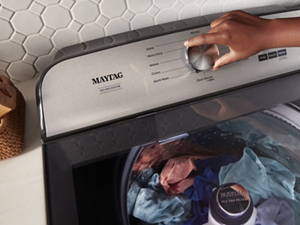  Person adjusting the controls on their Maytag® Pet Pro Washer