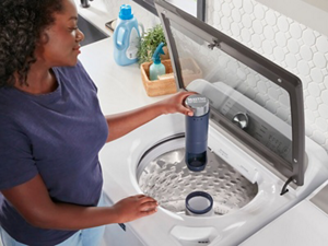 Person using a top load washing machine