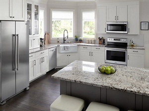 Suite of stainless steel Maytag® kitchen appliance in white cabinetry