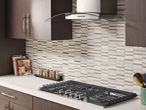 Kitchen with brown cabinets and stainless range hood