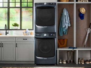 Stacked front load washer and dryer pair in a laundry room