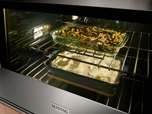 Two casserole dishes in an oven