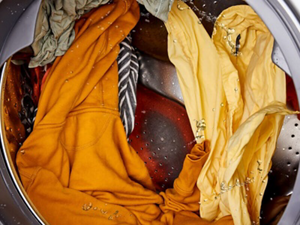 Wet clothes rotating inside a washer drum