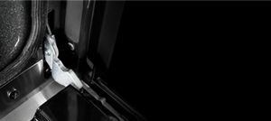 Close-up of wall oven door hinges.