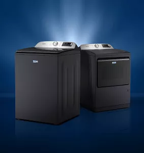 A Maytag® washer and dryer with a light behind it