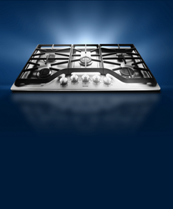 An electric cooktop against a dark background.